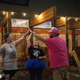 a group of people holding their hands in the air