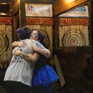two women hugging each other in front of targets