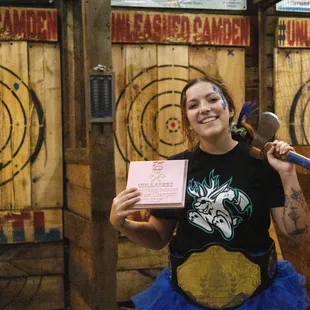 a woman in a tutu holding a trophy