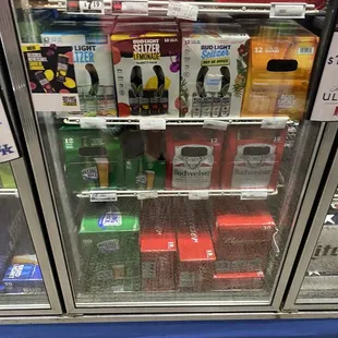 a display case with a variety of beverages