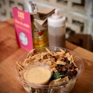 a salad in a plastic bowl