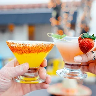 two people toasting with drinks