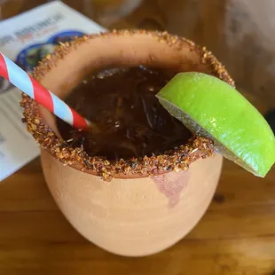 a drink with a straw and a lime