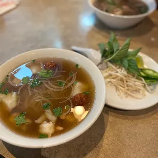 a bowl of soup and a plate of noodles