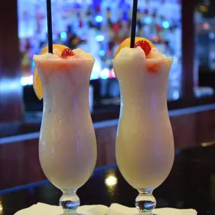two cocktails on a bar