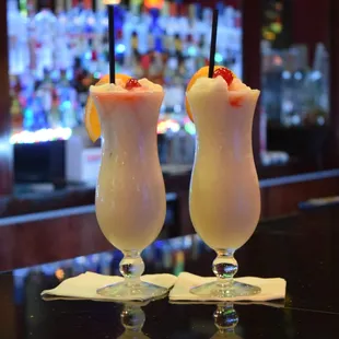 two cocktails on a bar