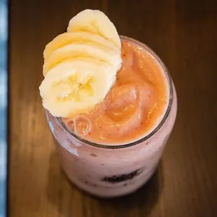 a smoothie with bananas on top