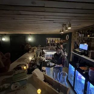 a woman behind a bar counter