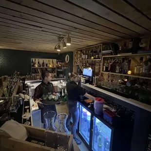 two people standing in a bar