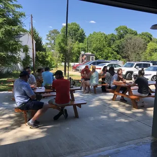 a group of people sitting at picnic tables