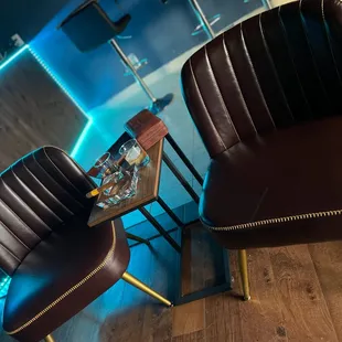 a pair of leather chairs in a room