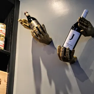 a hand holding a bottle of wine