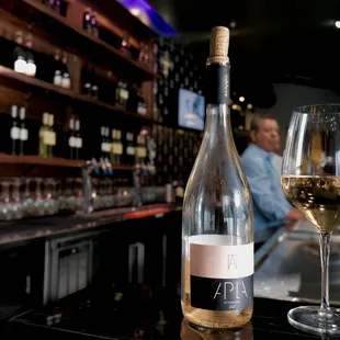 a glass of wine and a bottle of wine