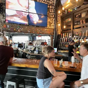 a group of people sitting at a bar