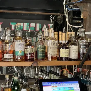 a man sitting at a bar with a laptop in front of him