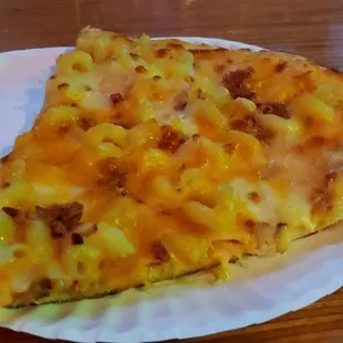 a slice of pizza on a paper plate