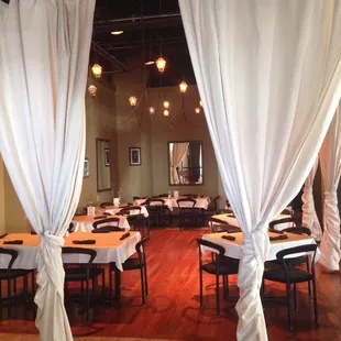 a dining room with white drapes