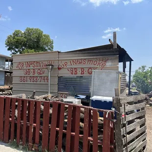 ows a man standing in front of a shack