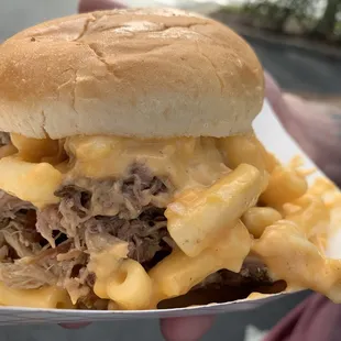 a pulled pork sandwich with macaroni and cheese