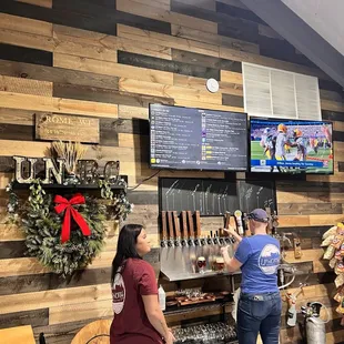 two women standing in front of a bar