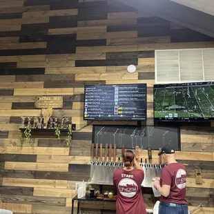 two people standing in front of a bar
