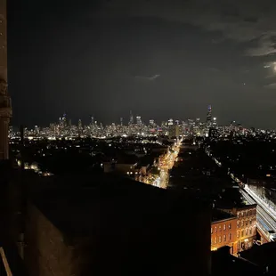 a man looking out over a city at night