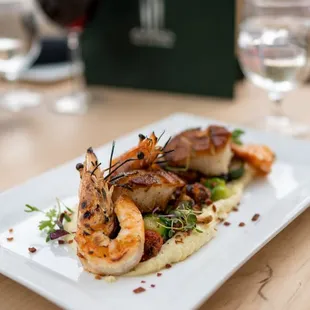 a plate of food and wine glasses