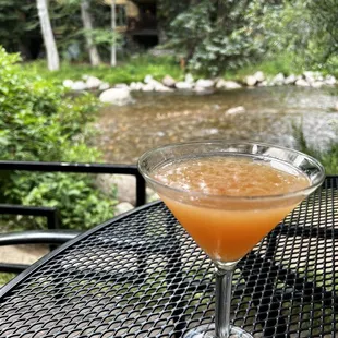 a glass of orange juice on a table