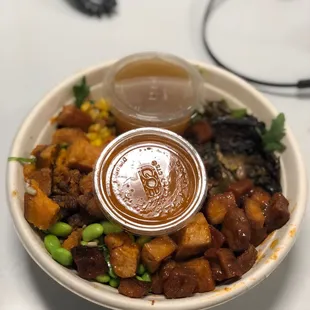 a bowl of food with sauce on top