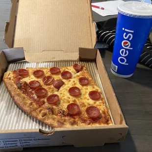 a slice of pepperoni pizza in a box