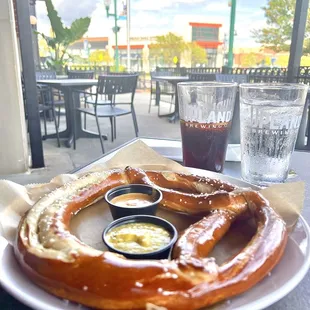 a plate of pretzels and a glass of beer