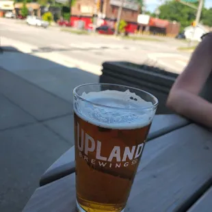a pint of beer on a picnic table