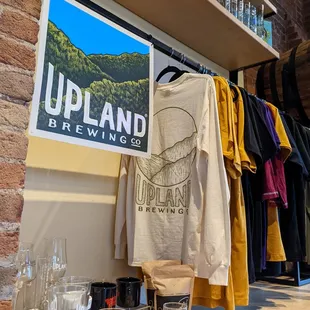 a display of beer glasses and t - shirts
