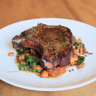 a steak on a bed of vegetables