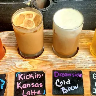 a variety of drinks on a wooden tray