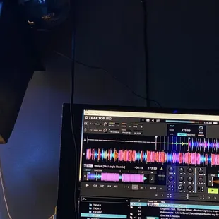 a laptop computer with sound waves on the screen