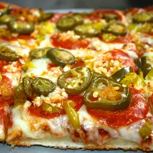Sicily's Mt. Etna with Pepperoni, chopped pepperoncinis,  jalapenos and garlic. Fiery good!