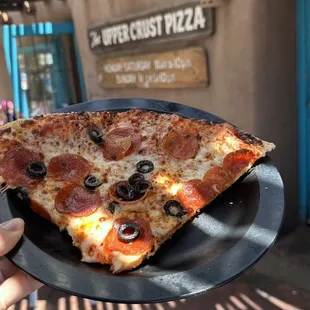 Two slices of pepperoni and olive pizza.