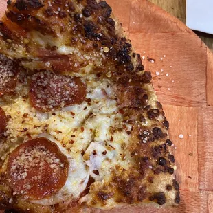 Burnt slice of pizza after waiting for twenty minutes.  Certainly never would experience this in NY or Chi city!