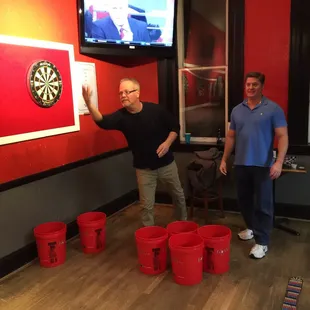 two men playing a game of darts