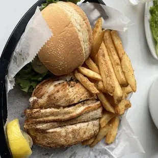 Grilled grouper sandwich with a side of fries. Good portion and tasty came with lettuce, tomato onion, and pickle and fries.
