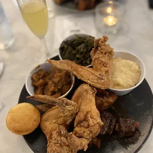 Soul food plate! Fried chicken, oxtails, grits, yams and collards!