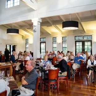 a large group of people sitting at tables