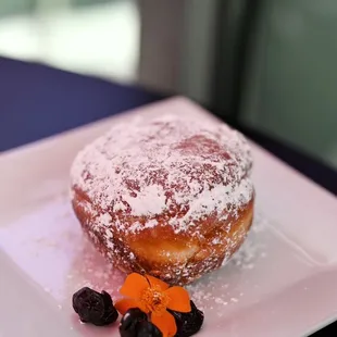 a powdered donut and berries