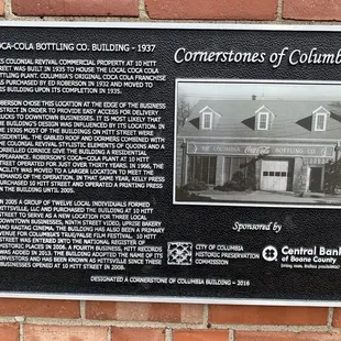 Plaque outside the record shoppe explains the history of the building.