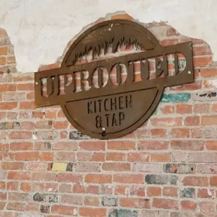a sign on a brick wall