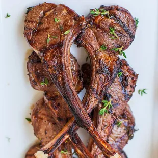 grilled lamb chops on a white plate