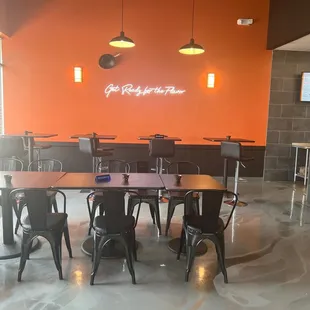 a dining room with orange walls