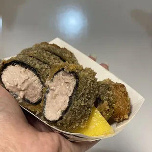 a hand holding a plate of food