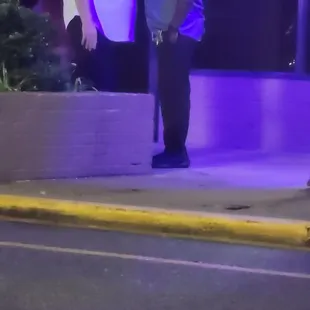 two men standing on the sidewalk